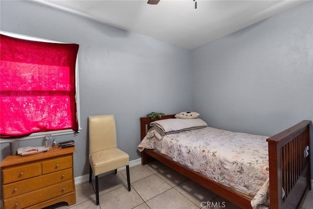 bedroom with light tile patterned floors, ceiling fan, and baseboards