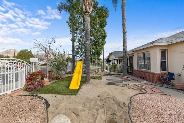 view of play area with a gate and fence