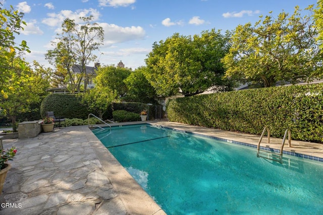 view of pool with a fenced in pool, a patio, and fence