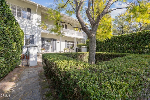 exterior space with a balcony and stucco siding