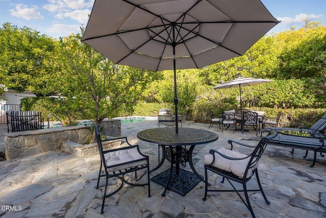 view of patio / terrace with outdoor dining space and an outdoor pool