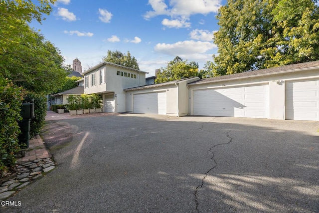 exterior space with community garages and stucco siding