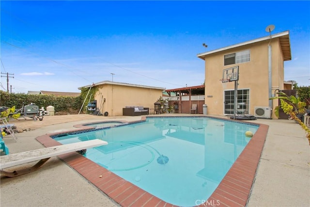 view of swimming pool featuring a diving board, an in ground hot tub, a patio, and a fenced in pool