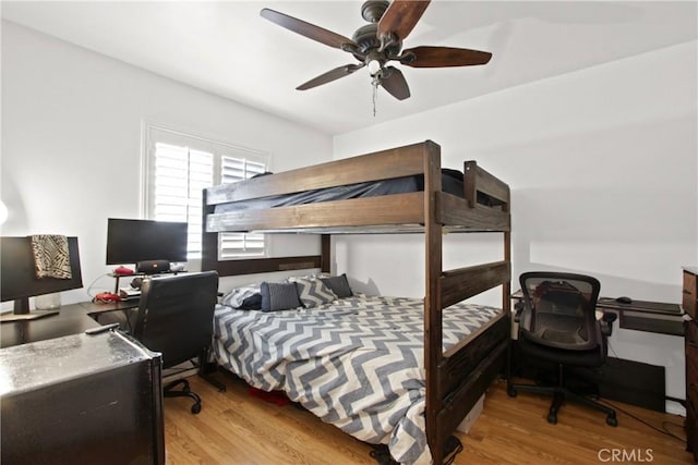 bedroom featuring a ceiling fan and wood finished floors