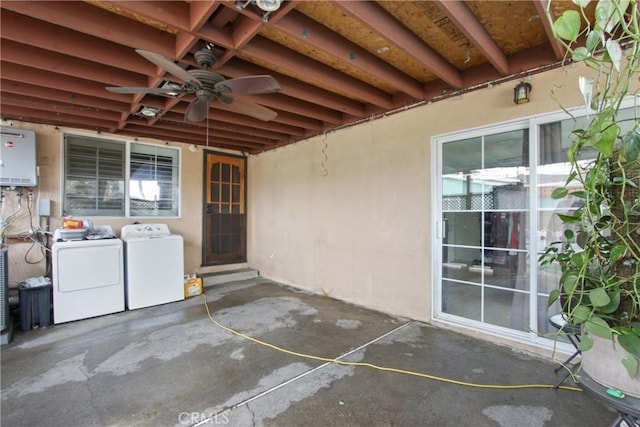 view of patio featuring water heater, ceiling fan, and separate washer and dryer