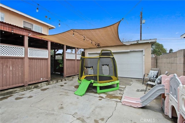 exterior space with a trampoline and fence