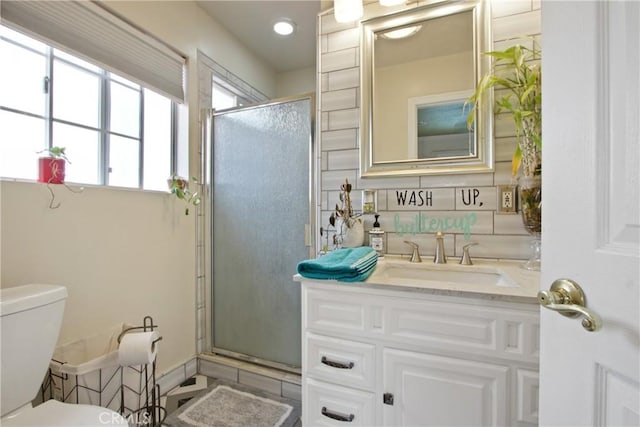 bathroom featuring toilet, a shower stall, tile patterned flooring, and vanity