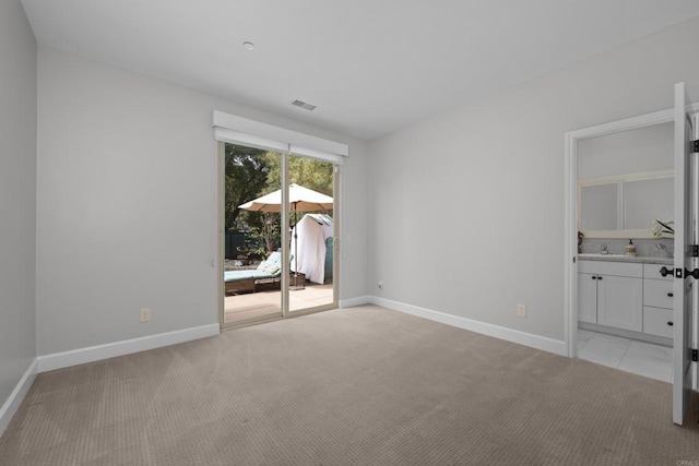 interior space with light carpet, visible vents, and baseboards