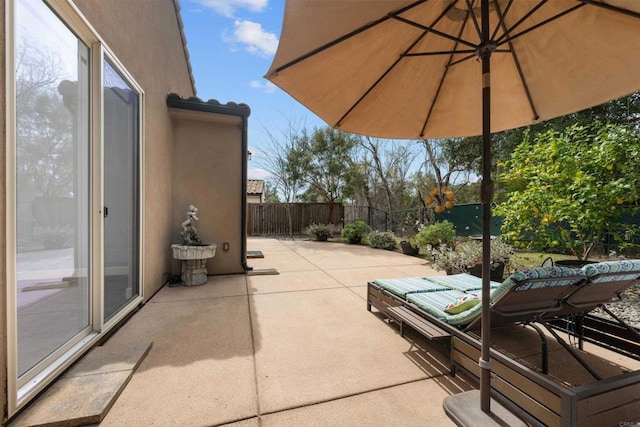 view of patio featuring fence