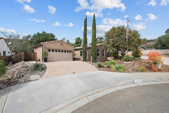 ranch-style home with an attached garage, fence, driveway, a tiled roof, and stucco siding