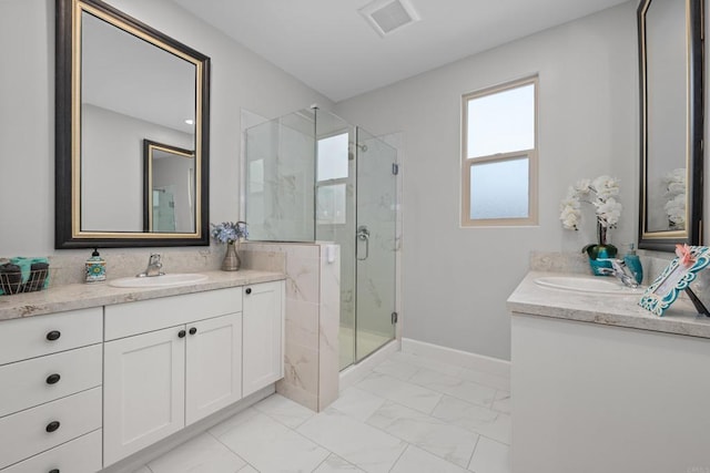 bathroom with marble finish floor, two vanities, a sink, and a marble finish shower