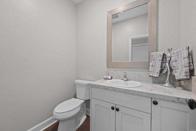 bathroom with toilet, visible vents, baseboards, and vanity