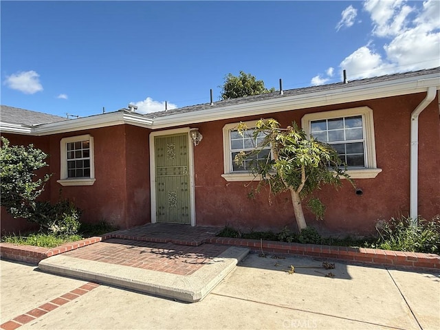 view of front of house featuring a patio area and stucco siding