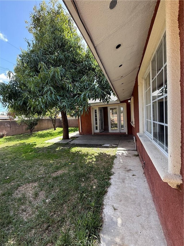 view of yard featuring fence and a patio