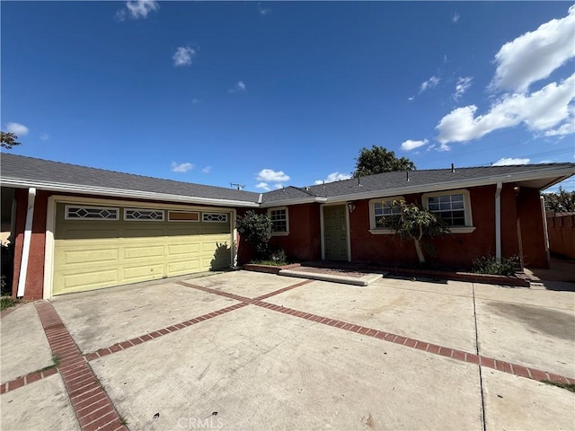 ranch-style house featuring driveway and an attached garage