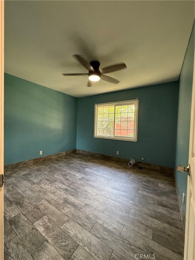 spare room with a ceiling fan and wood finished floors