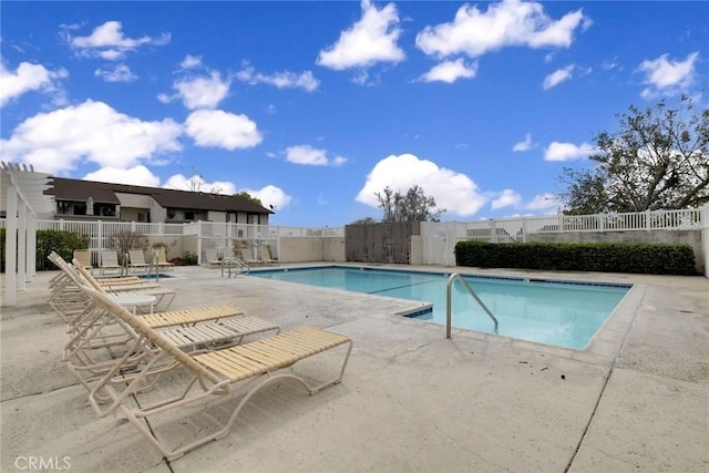 pool with a patio and fence