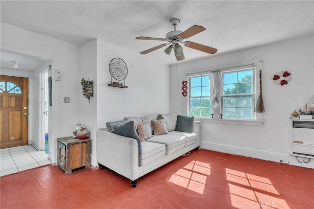 living room with wood finished floors, baseboards, heating unit, and ceiling fan