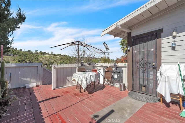 wooden terrace featuring fence