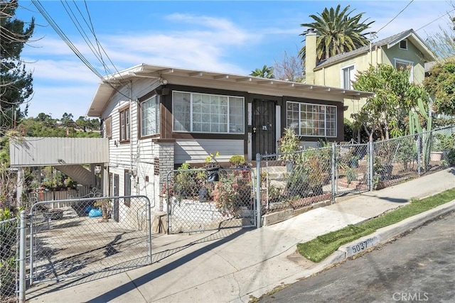 view of front of house featuring a fenced front yard and a gate