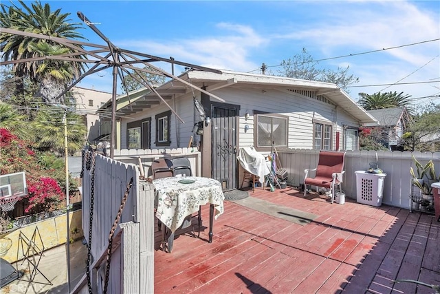 exterior space featuring fence and a wooden deck