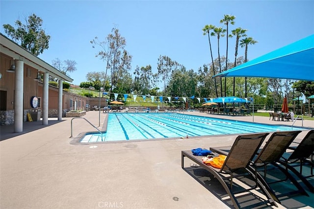 pool featuring a patio area and fence