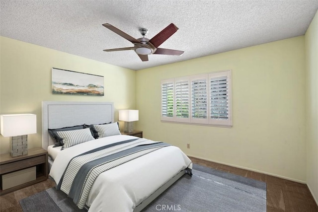 bedroom with a ceiling fan, baseboards, and a textured ceiling