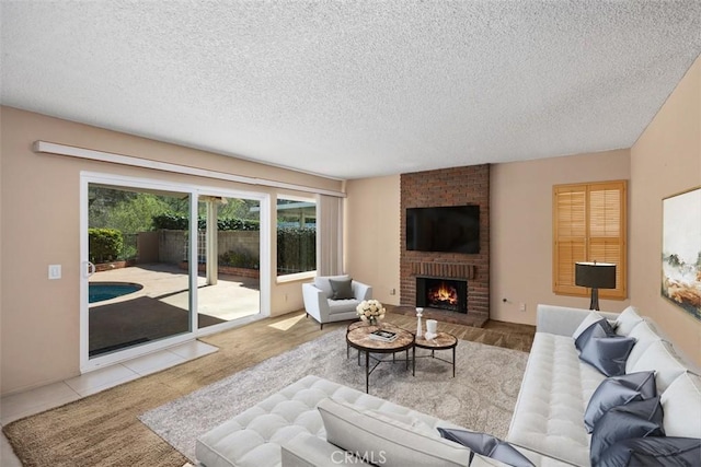 tiled living area with a fireplace and a textured ceiling