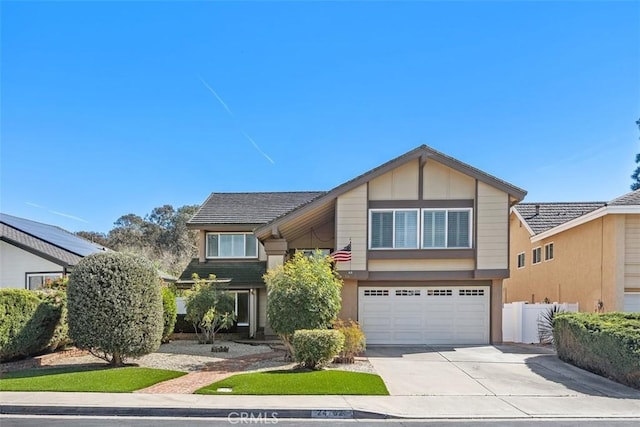 view of front of home featuring stucco siding, driveway, an attached garage, and fence