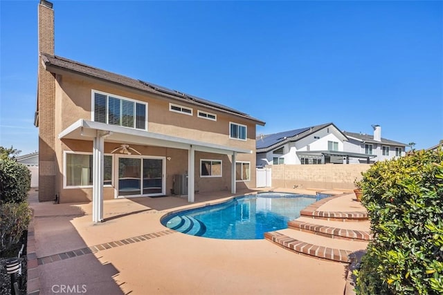 view of swimming pool featuring a ceiling fan, a fenced in pool, fence, central air condition unit, and a patio area