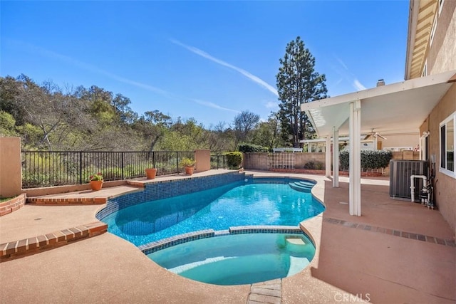 view of pool with a patio area, a pool with connected hot tub, and a fenced backyard