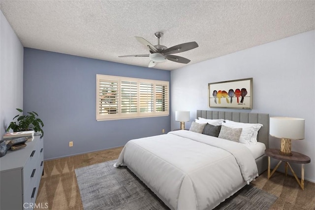 carpeted bedroom featuring baseboards, a textured ceiling, and a ceiling fan