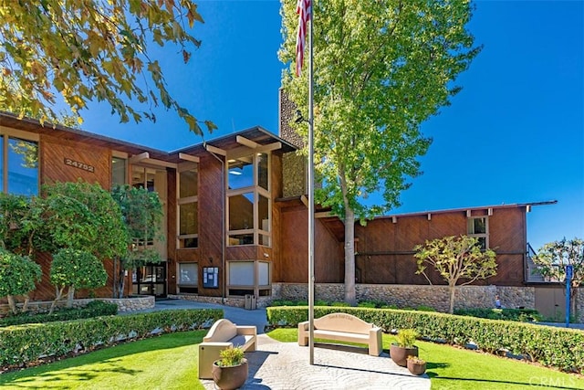 view of home's community featuring a patio area and a yard