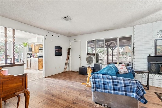 interior space featuring visible vents, multiple windows, and wood finished floors