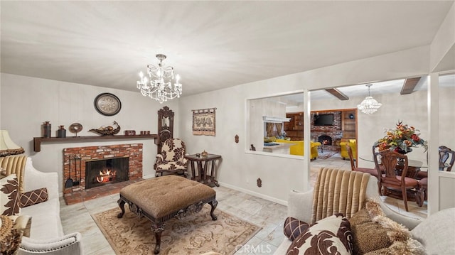 living room with a brick fireplace, baseboards, and a chandelier