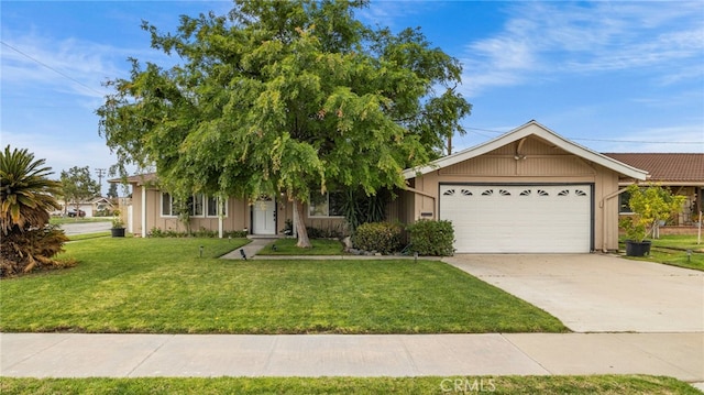 view of front of house featuring concrete driveway, a front lawn, and an attached garage