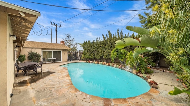 pool with fence private yard, a patio, and outdoor dining space