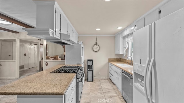 kitchen featuring recessed lighting, under cabinet range hood, stainless steel appliances, a sink, and white cabinetry