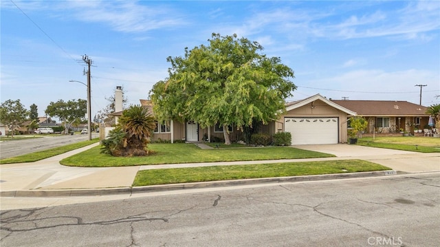 view of front facade with driveway, a front lawn, an attached garage, and stucco siding