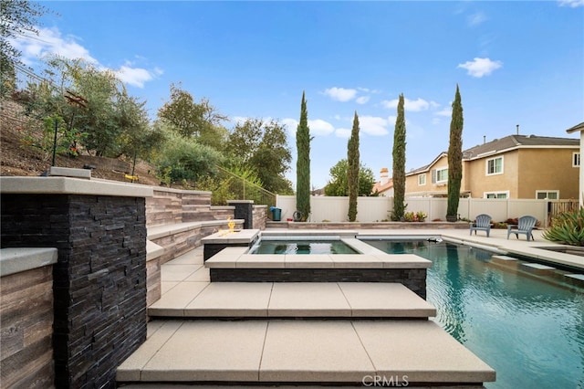 view of swimming pool with a patio, a fenced backyard, a fenced in pool, and an in ground hot tub