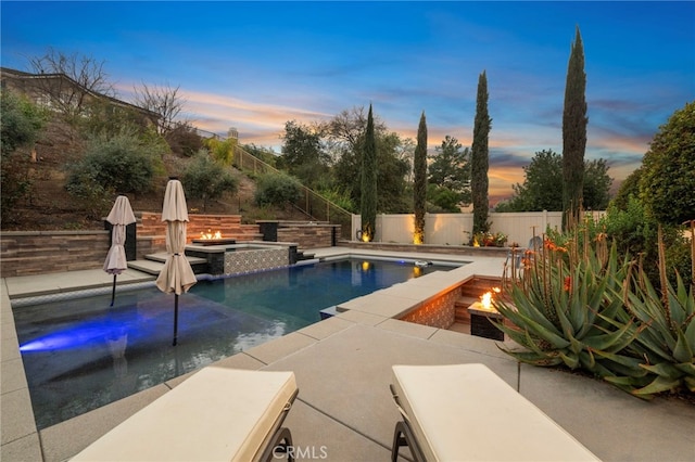 view of pool featuring a fenced in pool, a patio area, a fenced backyard, and a fire pit