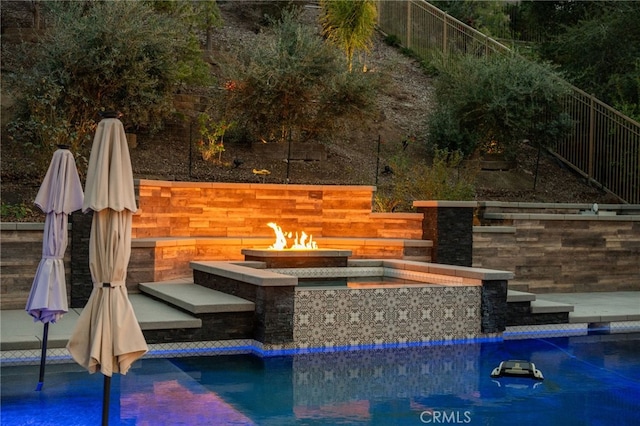 view of swimming pool featuring a fenced in pool, an outdoor fire pit, and fence