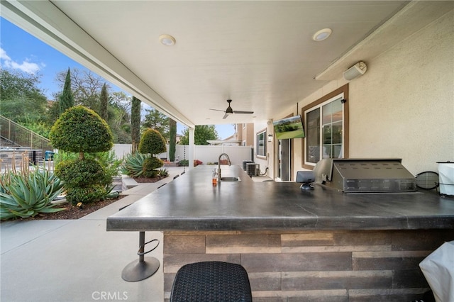 view of patio featuring ceiling fan, grilling area, area for grilling, and a fenced backyard