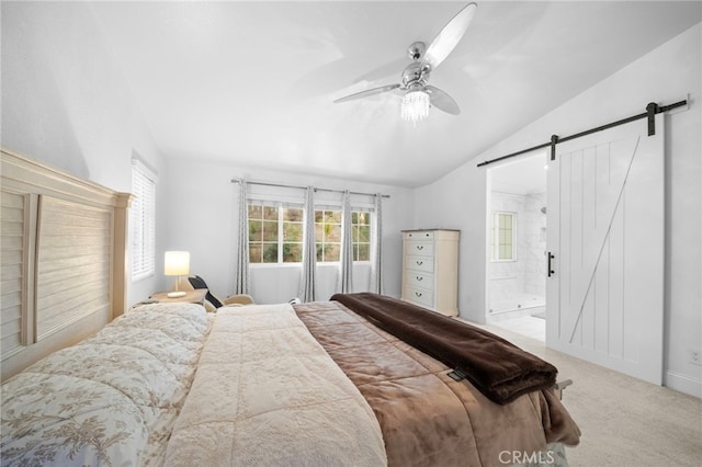 carpeted bedroom featuring lofted ceiling, a barn door, a ceiling fan, and ensuite bathroom