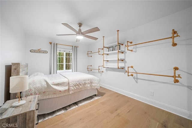 bedroom featuring baseboards and wood finished floors