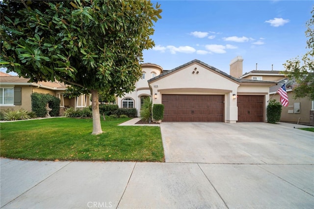 mediterranean / spanish-style home with an attached garage, stucco siding, driveway, and a front yard