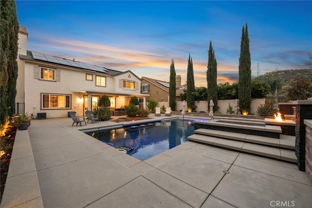 view of swimming pool with a patio, an outdoor fire pit, a fenced backyard, and a fenced in pool