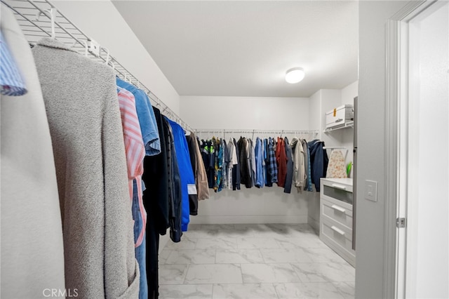 spacious closet with marble finish floor