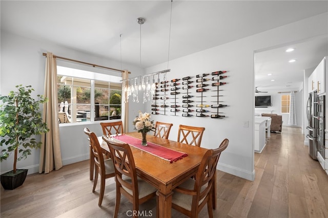 dining area with light wood-type flooring, baseboards, and recessed lighting