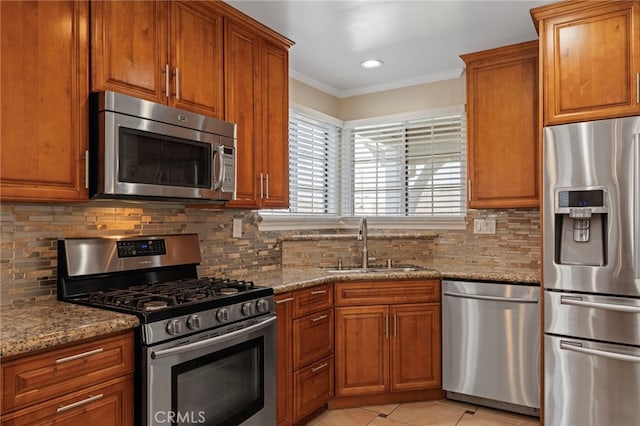 kitchen with brown cabinets, stainless steel appliances, and a sink